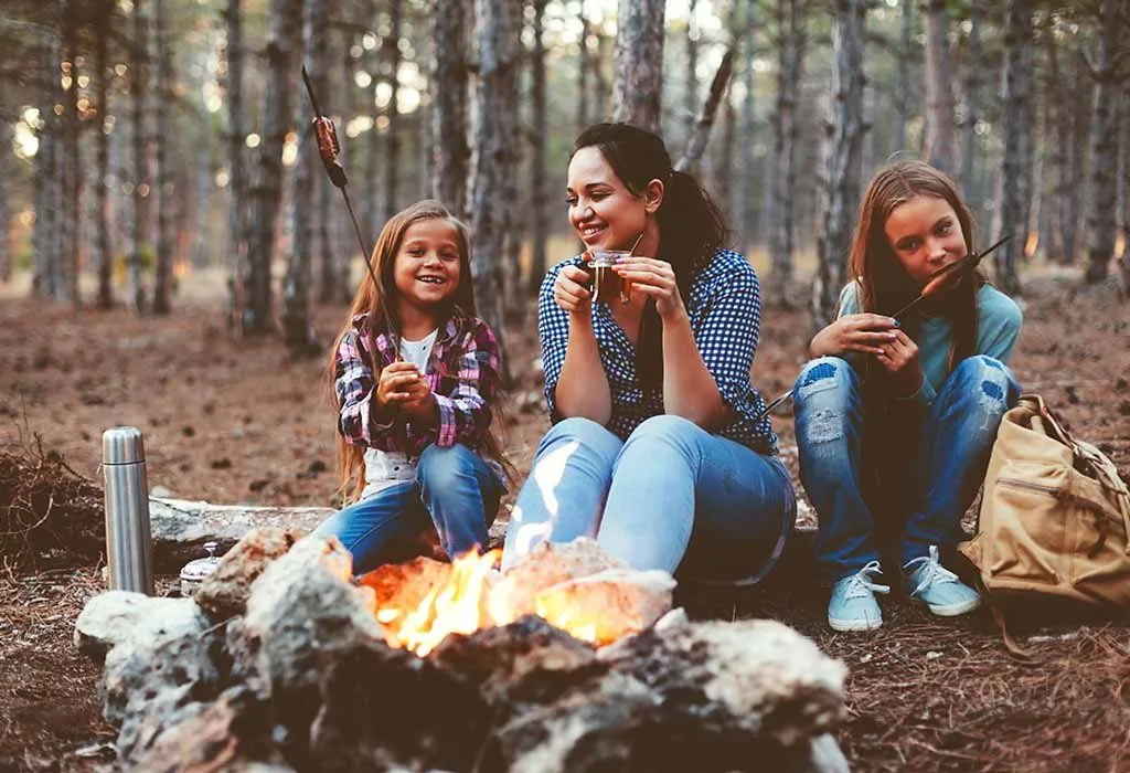 Mother and daughters enjoying a campfire