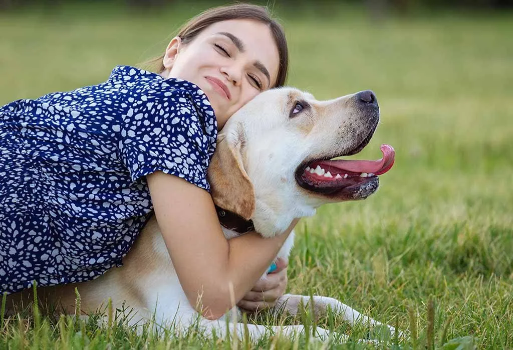 A happy woman hugging her dog