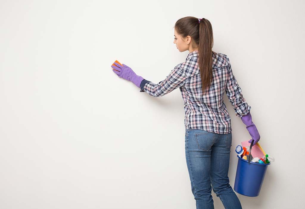 Woman cleaning her wall