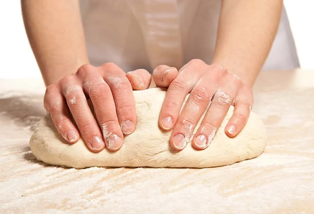 A woman kneading the dough