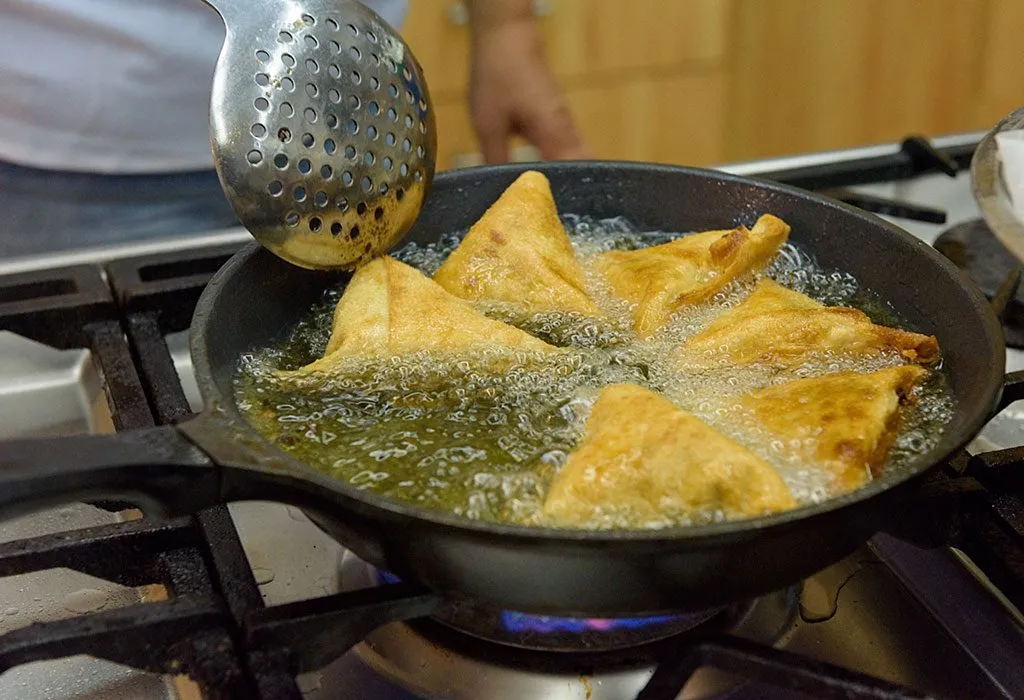 Deep frying samosas