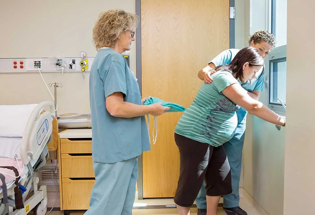 A pregnant woman in labour walking around