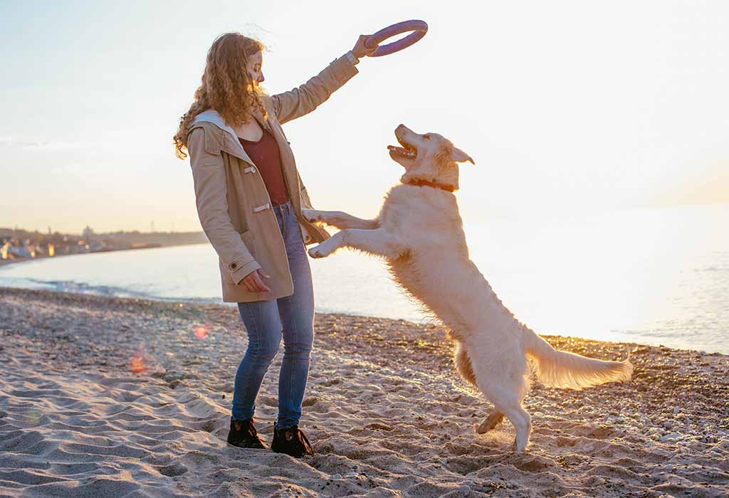 A woman playing with her dog