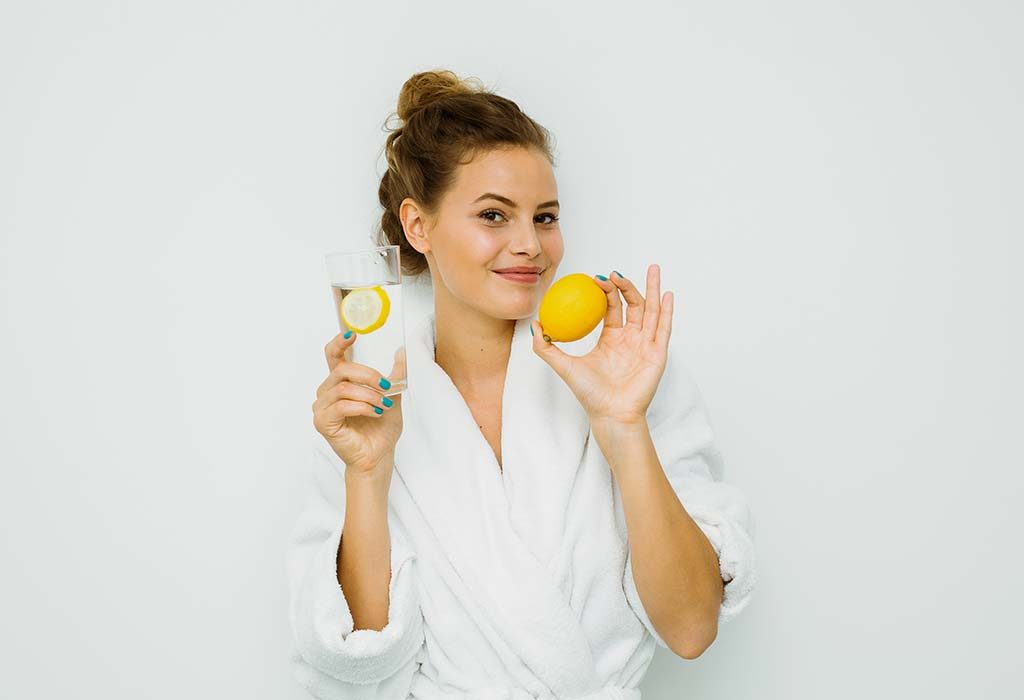 A woman drinking lemon water