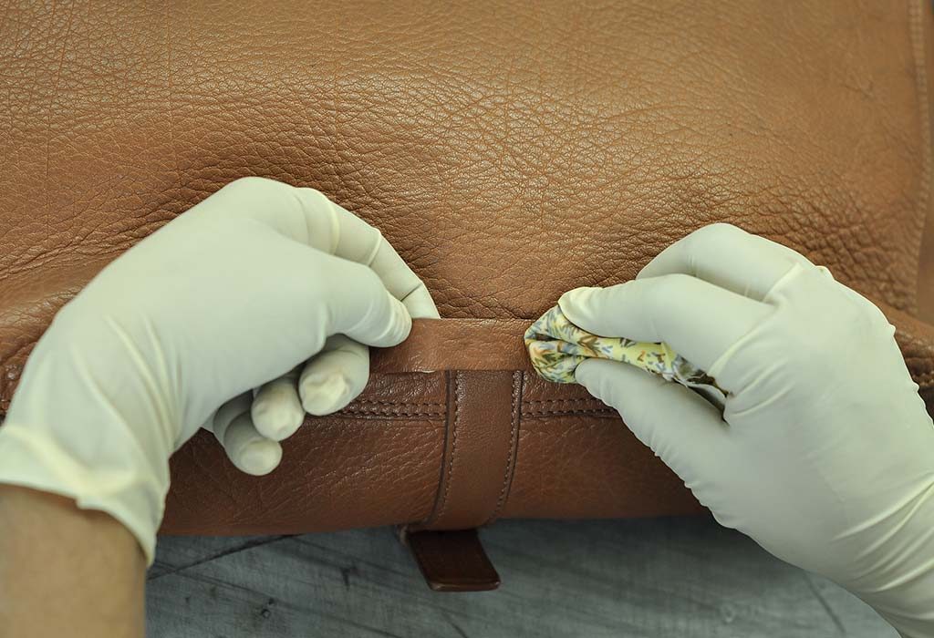 A leather bag being cleaned by a professional