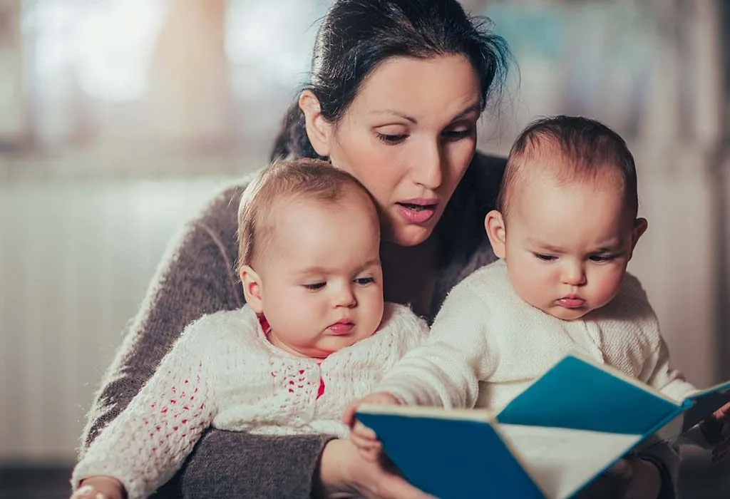 mother reading to twins