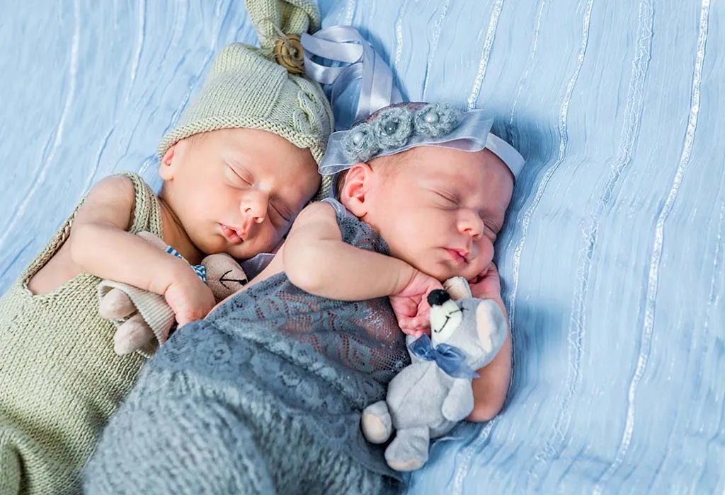 twins sleeping with toys