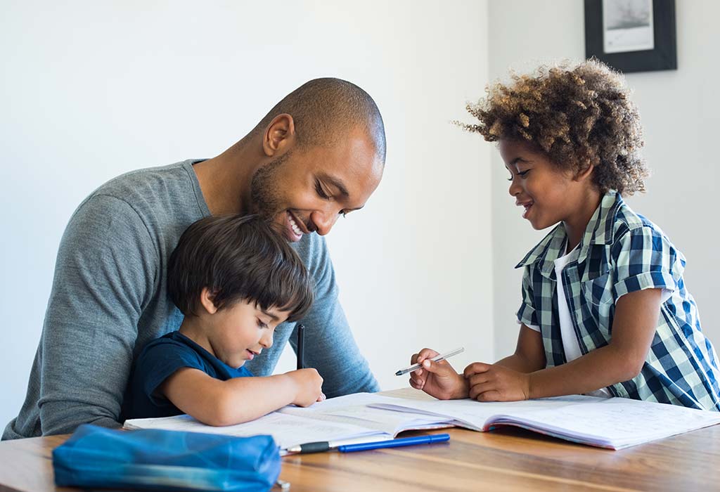 father helping kids with homework