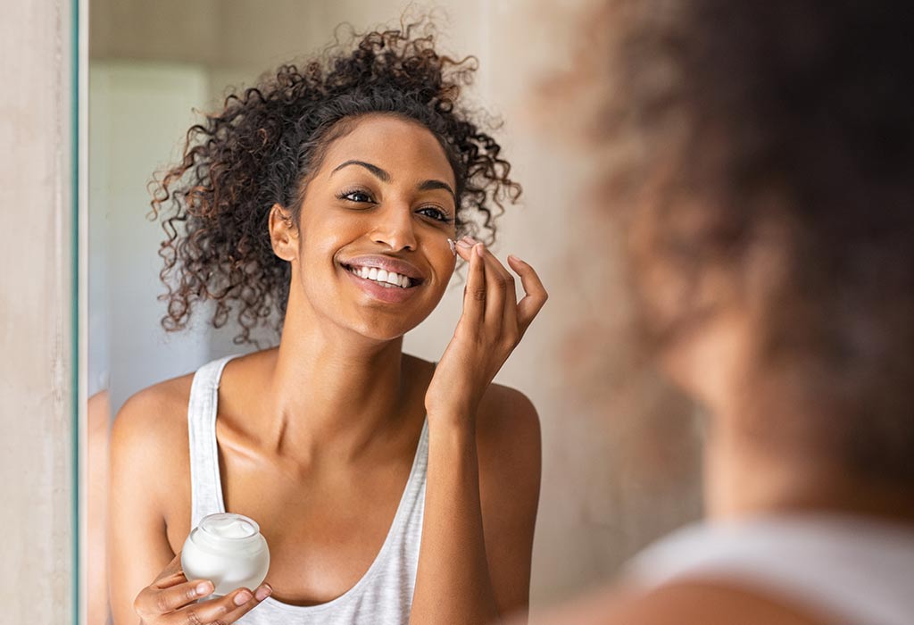 Women applying cream on her face