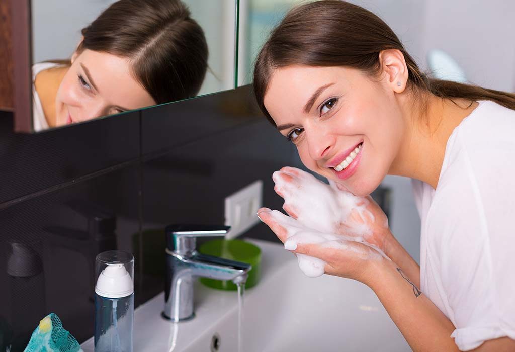 A woman washing her face