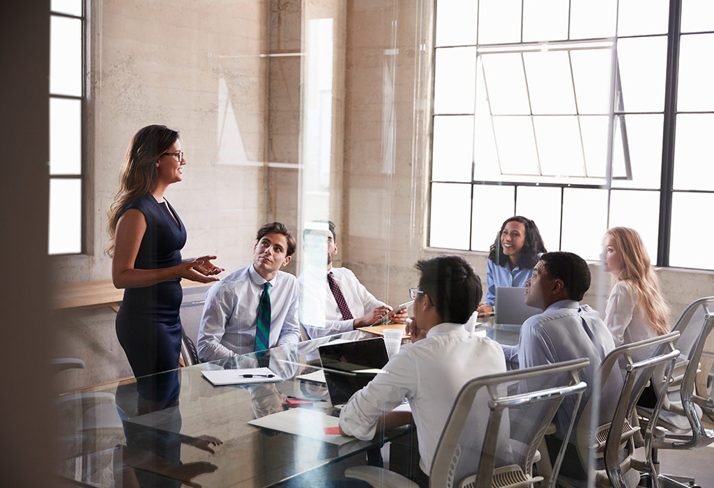 A woman addressing a group of people
