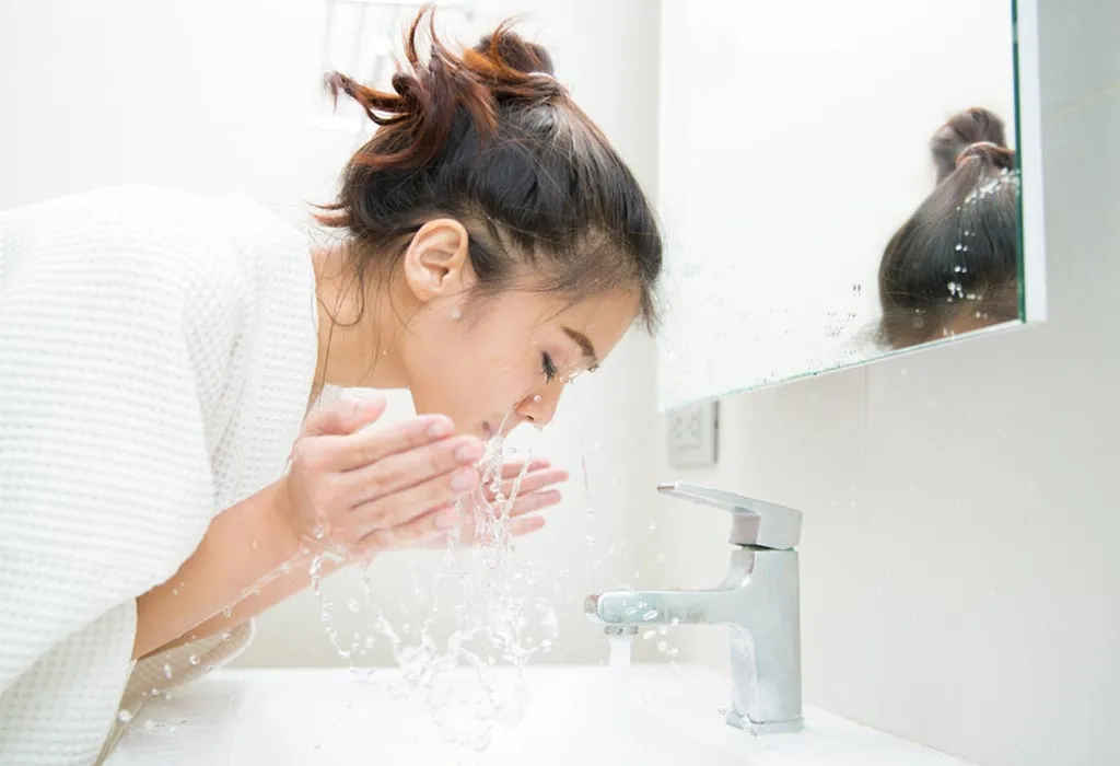 A woman washing her face