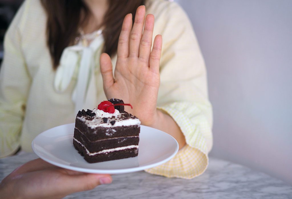 Woman saying no to cake