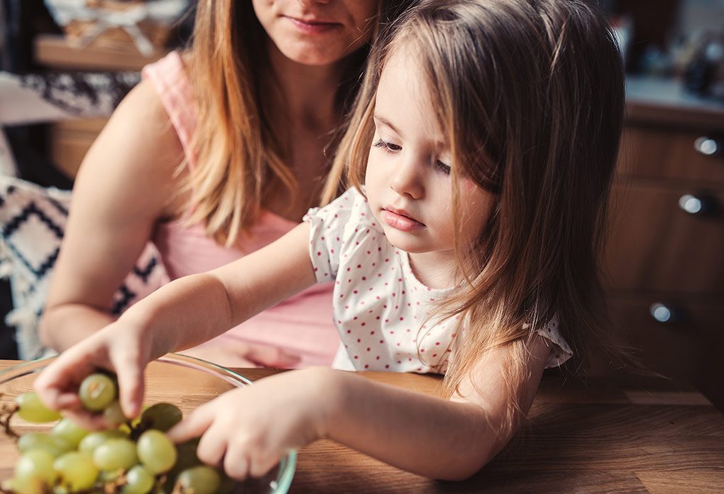 Toddler eating fruits