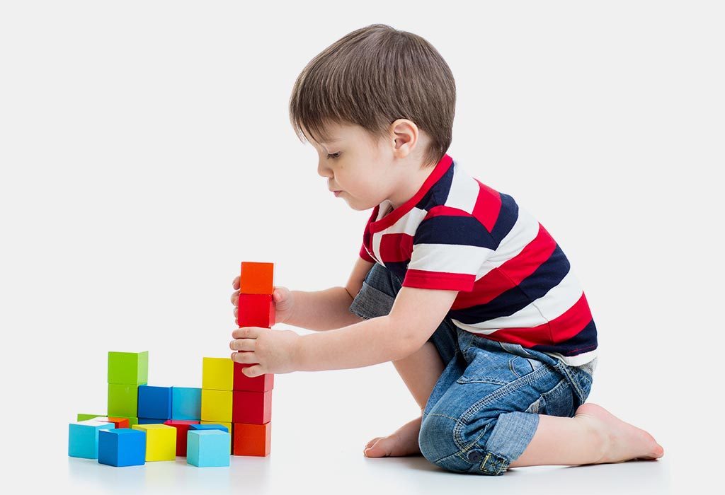 A toddler stacking cups