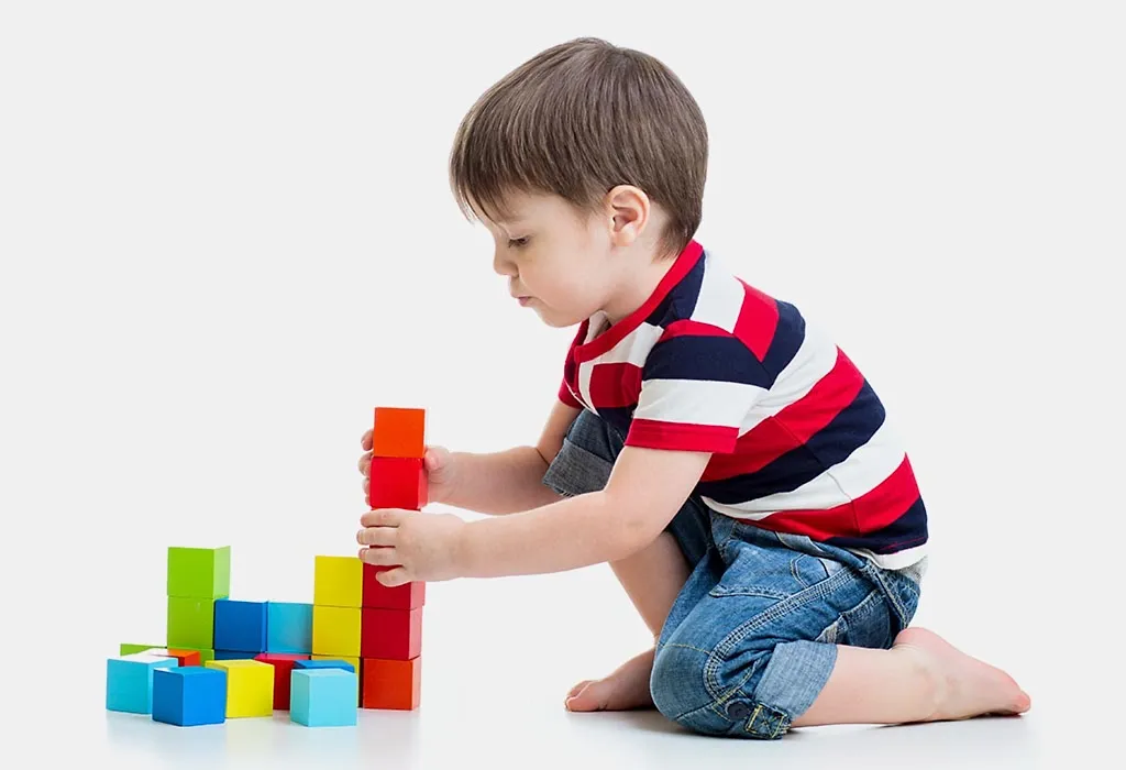 A toddler stacking cups