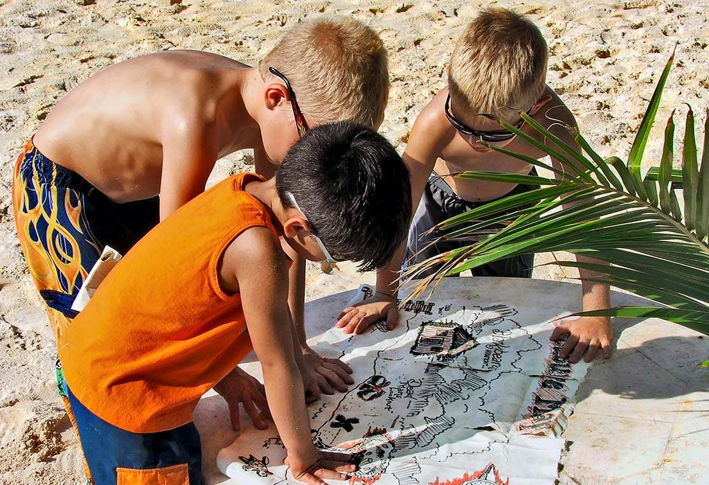 children enjoying a treasure hunt on the beach