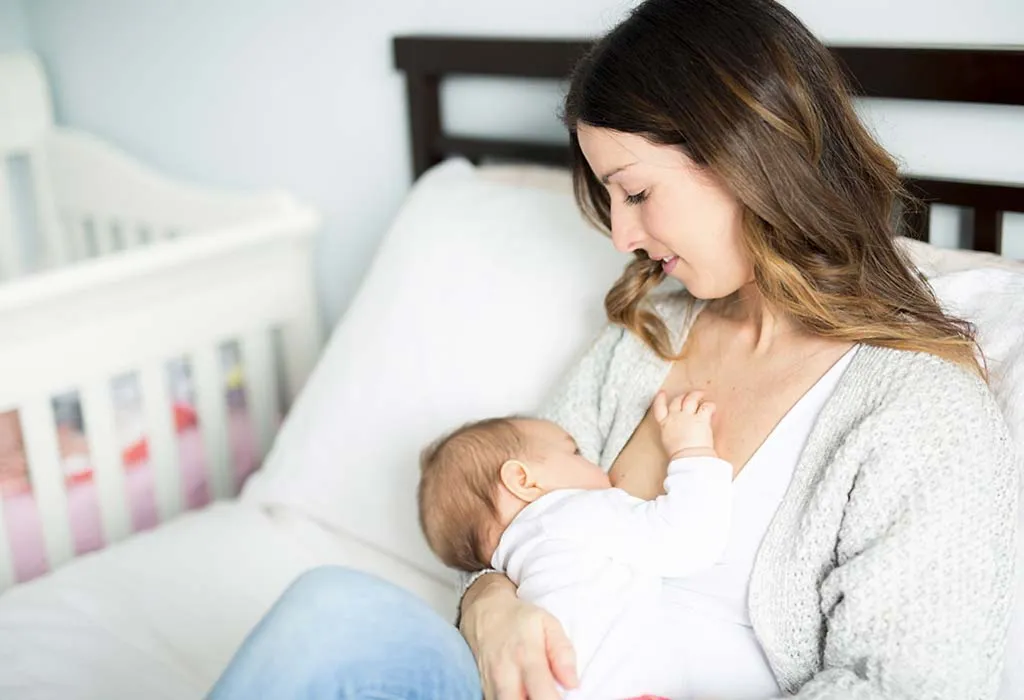 A young mother nursing her child