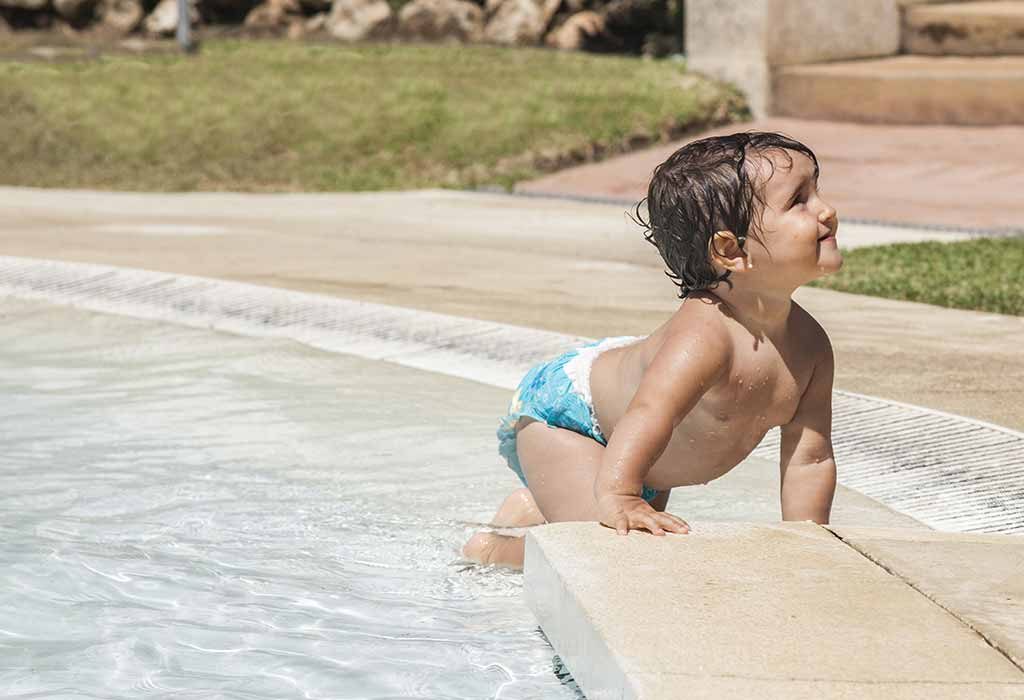 kid crawling near a pool