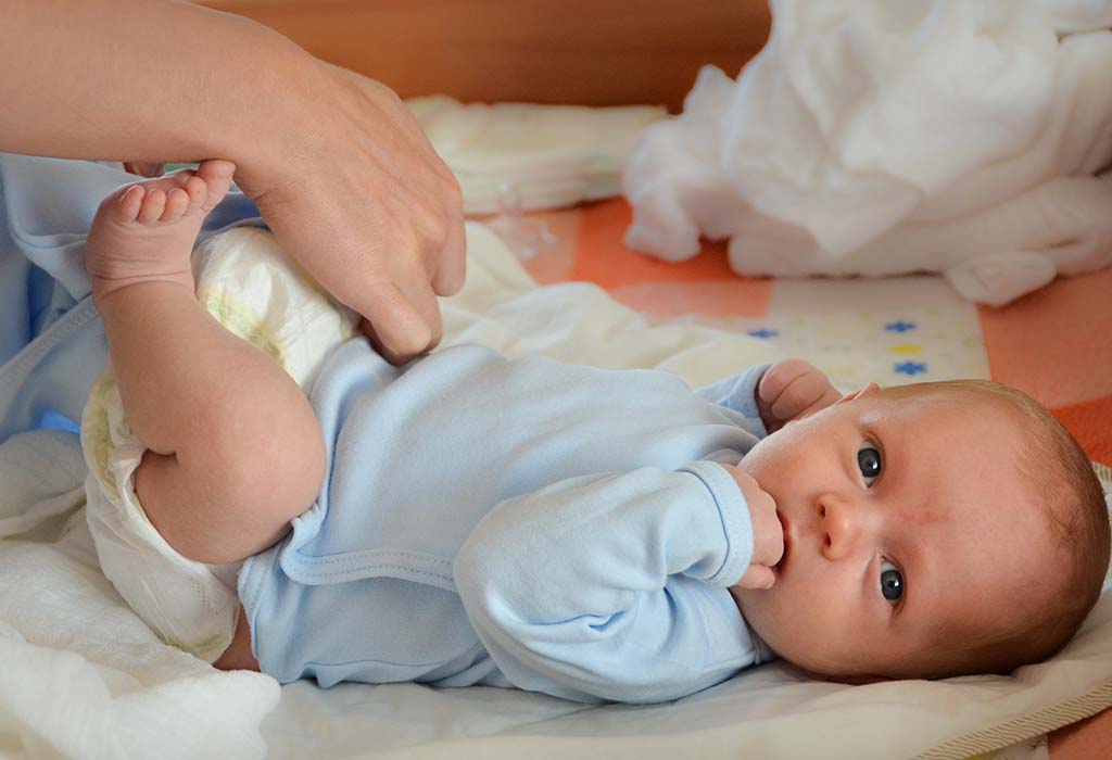 mother changing baby's diaper