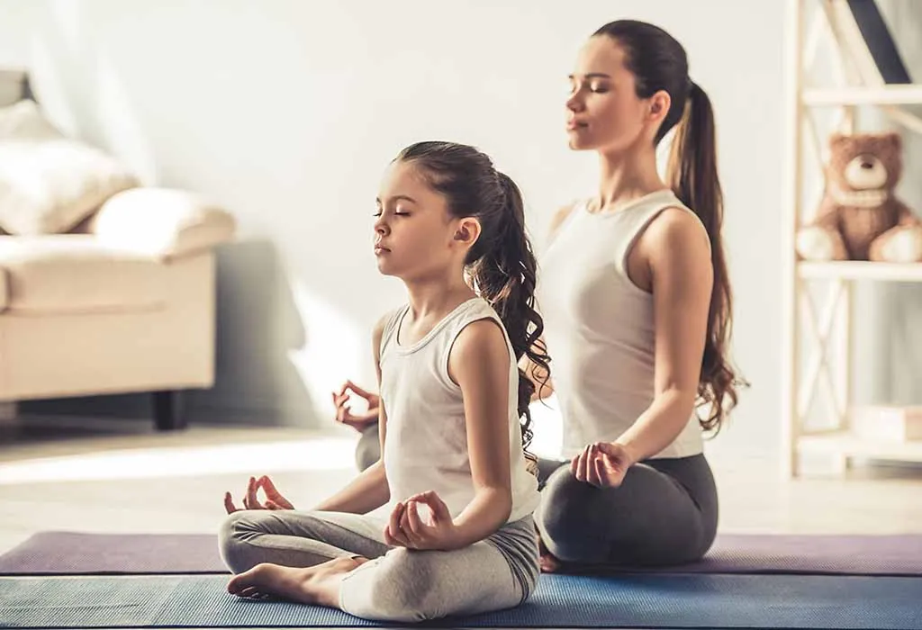 child meditating with mother