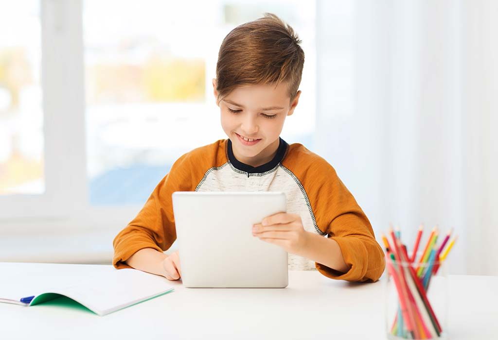 A boy using a tablet for educational purpose
