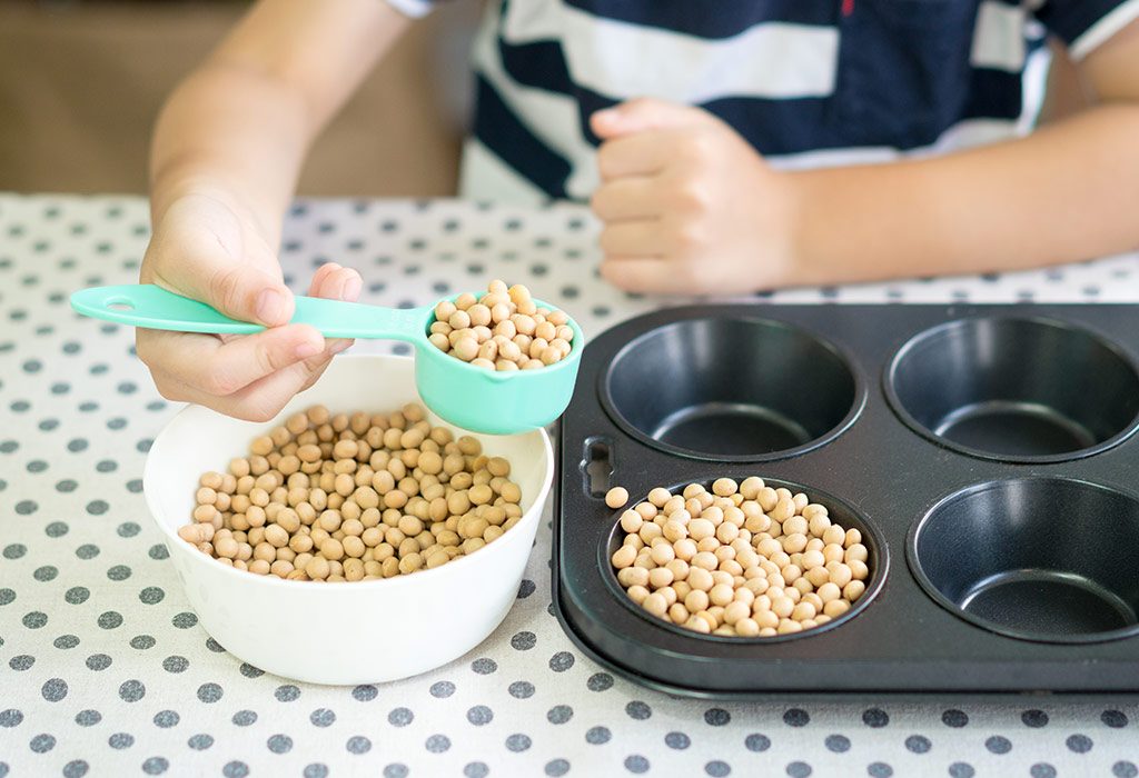 child scooping beans into a mould