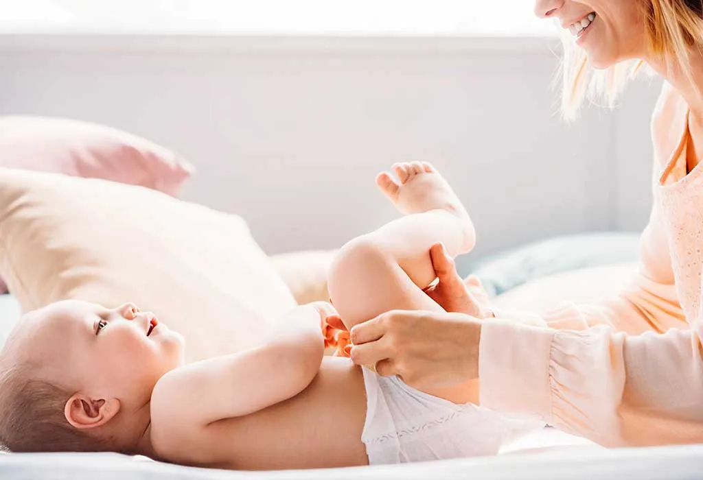 mother changing baby's diaper
