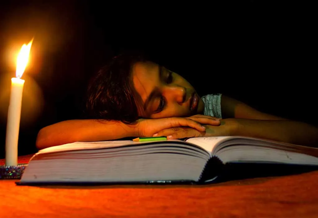 Child Studying in candle light