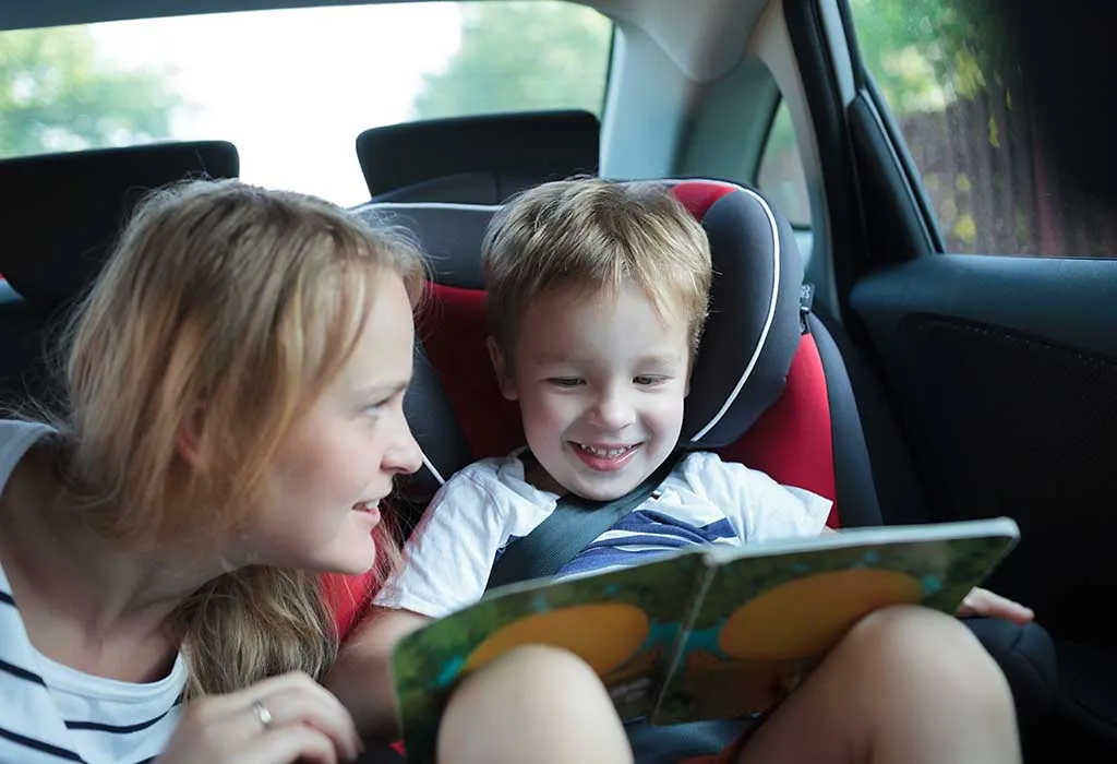 kid reading a book in the car