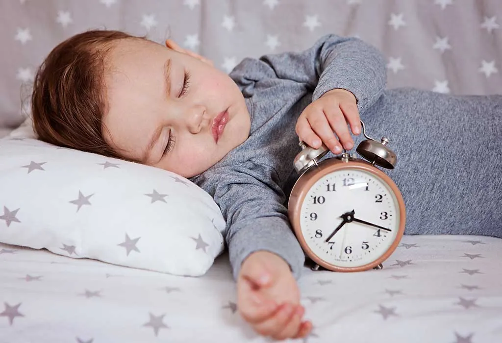 sleeping baby with clock