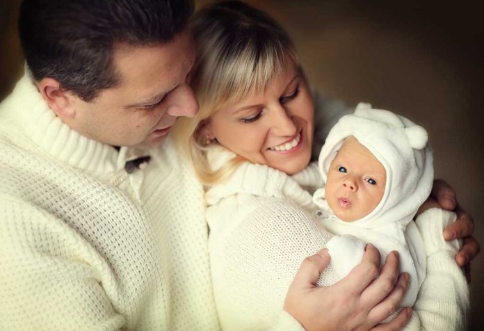 parents and baby enjoying winter
