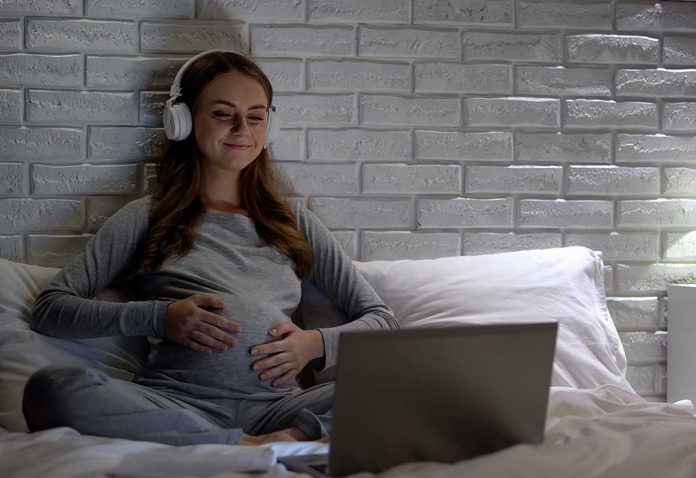 pregnant woman watching a movie