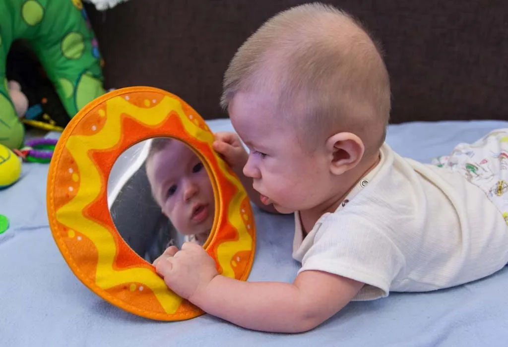 newborn with a mirror