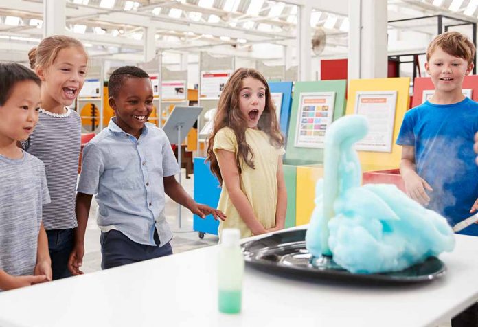 kids amazed watching a science experiment in a museum