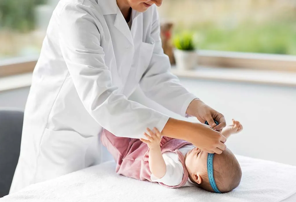 Doctor measuring baby head circumference. Pediatrician place