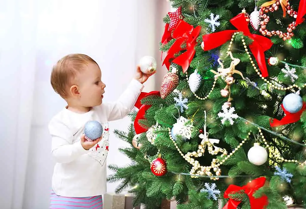 baby decorating Christmas tree