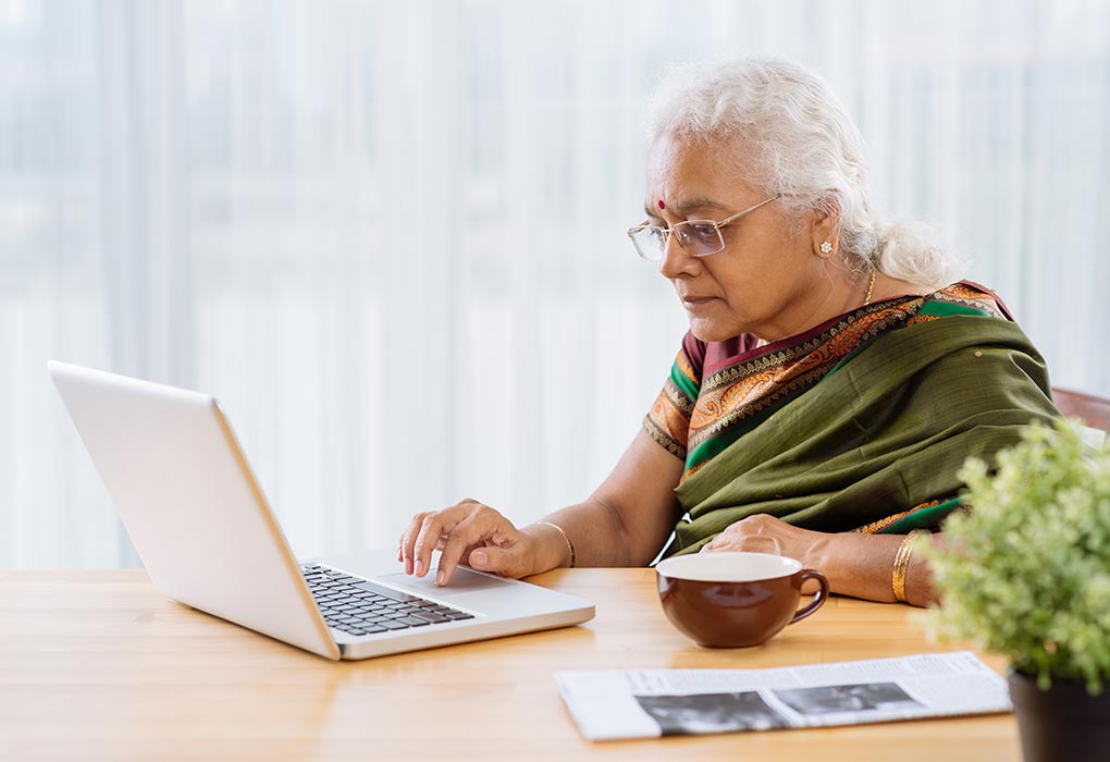 An old woman reading about Coronavirus