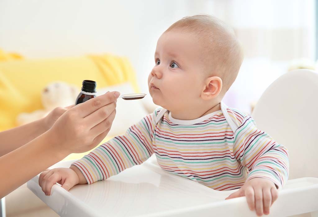 A mother giving medicines to her baby