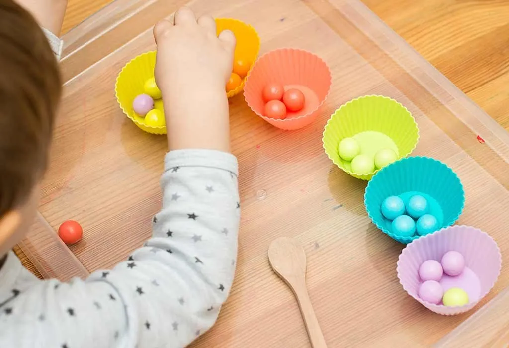 Toddler sorting coloured candies