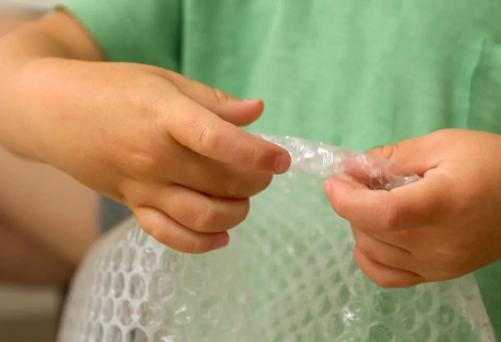 Kid bursting bubble wrap