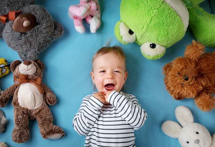 16-month-old toddler with his stuffed toys