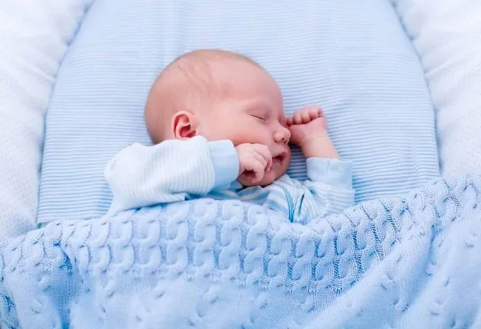 newborn baby sleeping with a blanket