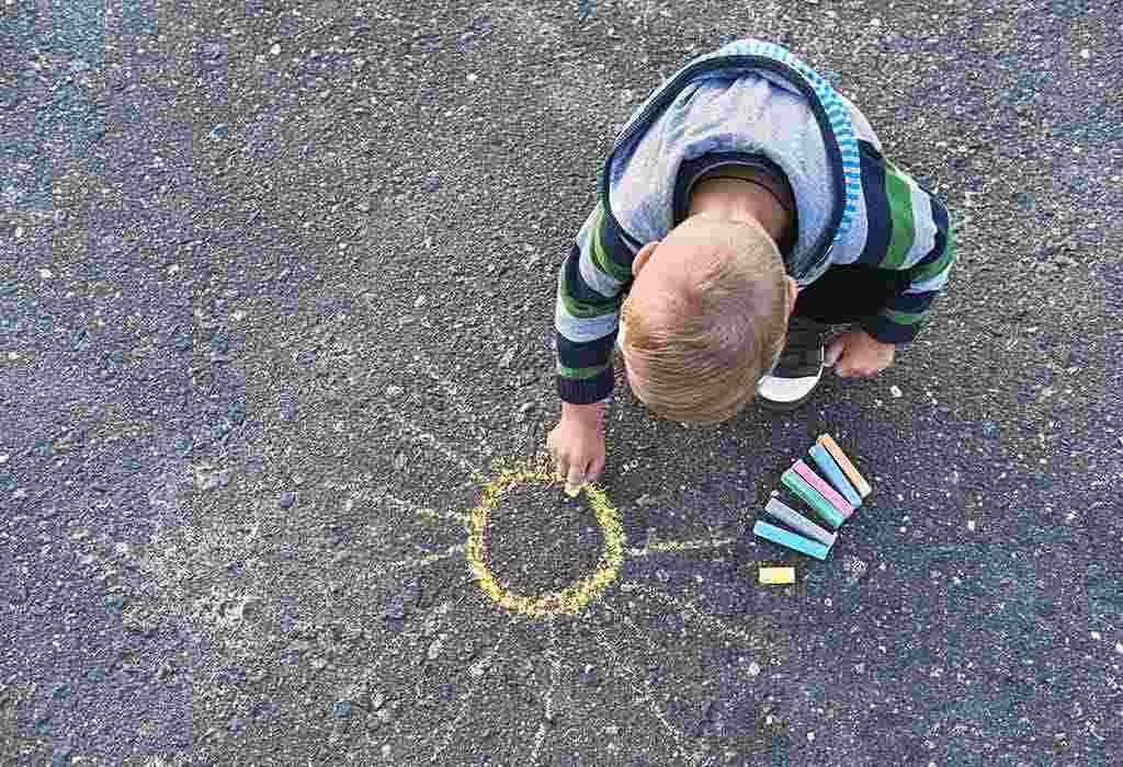 toddler painting sidewalk