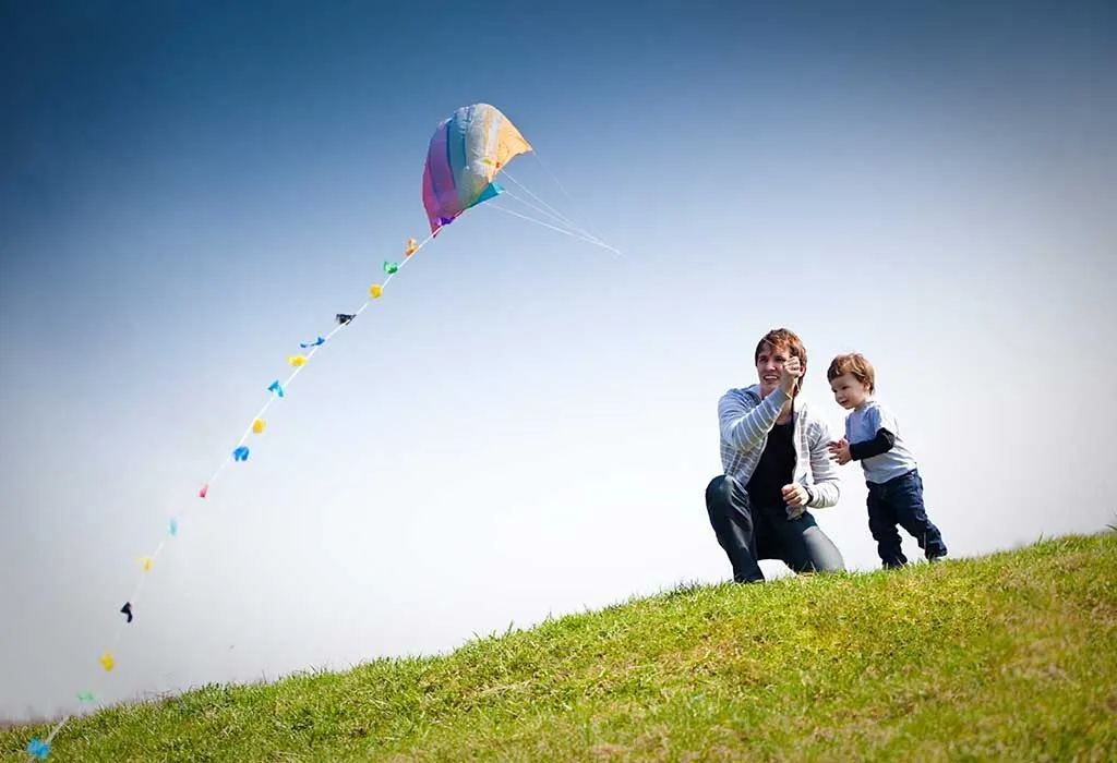 father and son flying a kite