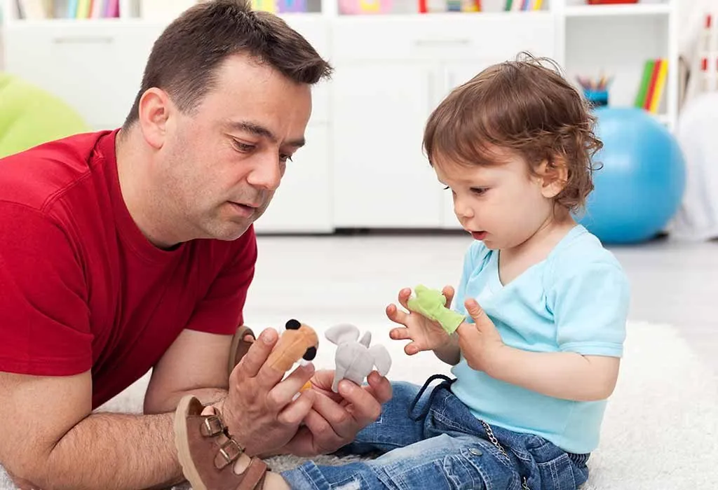 toddler with hang puppet