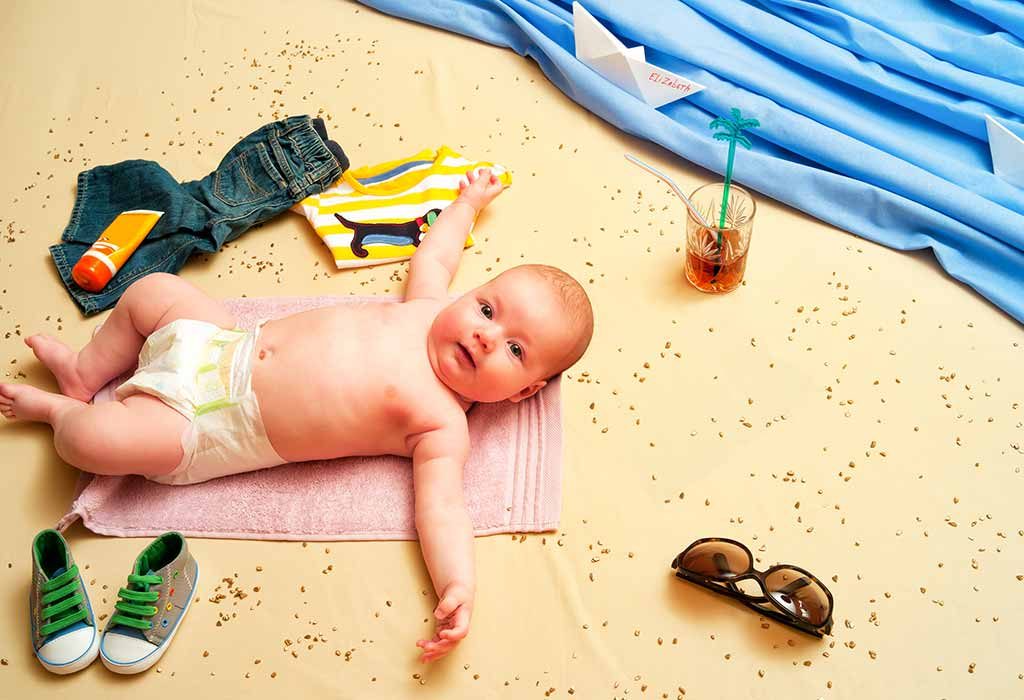 baby lying on beach-themed props at home