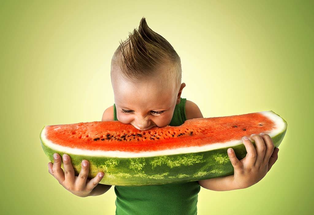 baby taking a bite from a big slice of watermelon