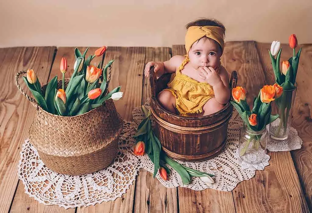 high camera angle of a baby in a bucket