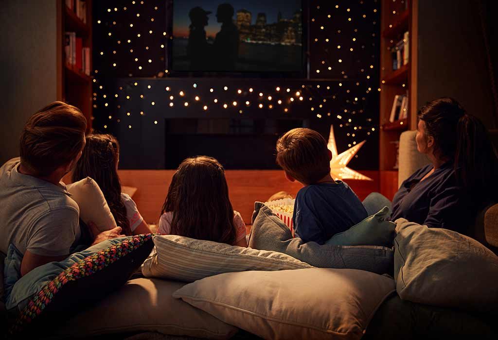 Family watching a movie at home